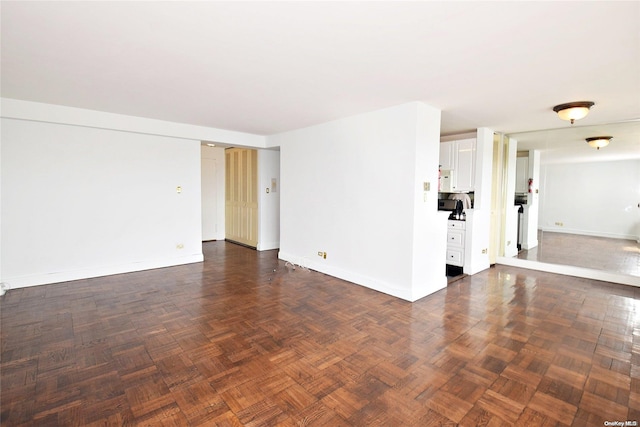 spare room with dark parquet floors