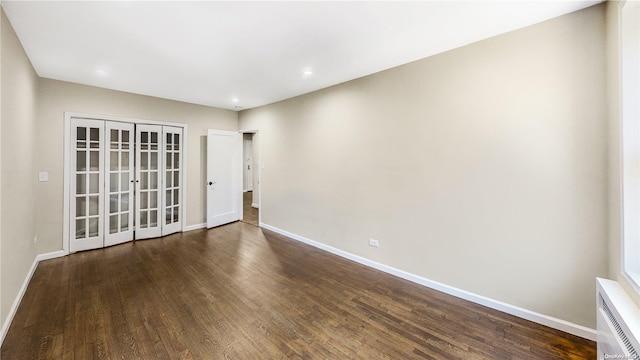 empty room featuring dark hardwood / wood-style flooring and french doors