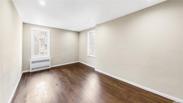 empty room with dark wood-type flooring