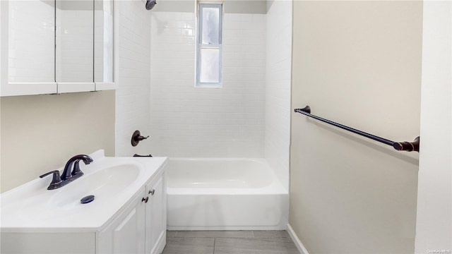 bathroom featuring tile patterned floors, vanity, and tiled shower / bath