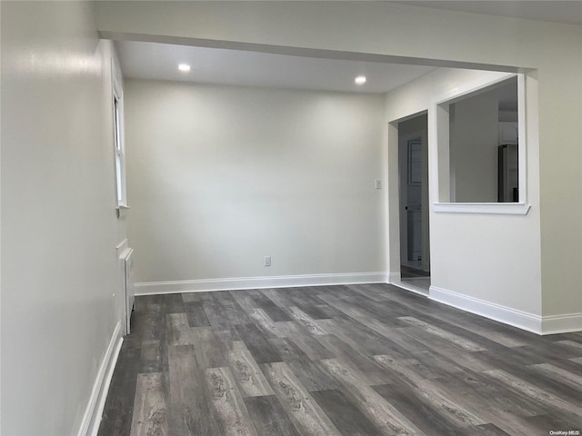 empty room featuring dark hardwood / wood-style flooring