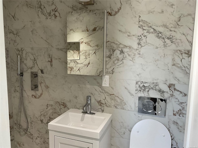 bathroom with a shower, vanity, and tile walls