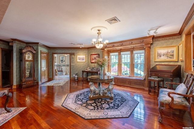 interior space featuring hardwood / wood-style floors, ornamental molding, and a chandelier