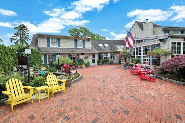 rear view of property featuring a patio area