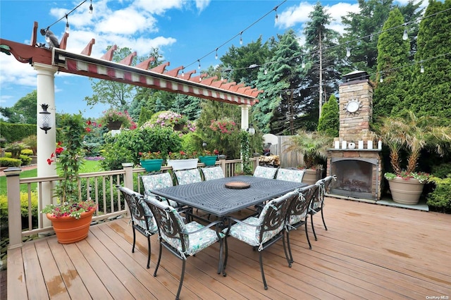 deck with an outdoor stone fireplace