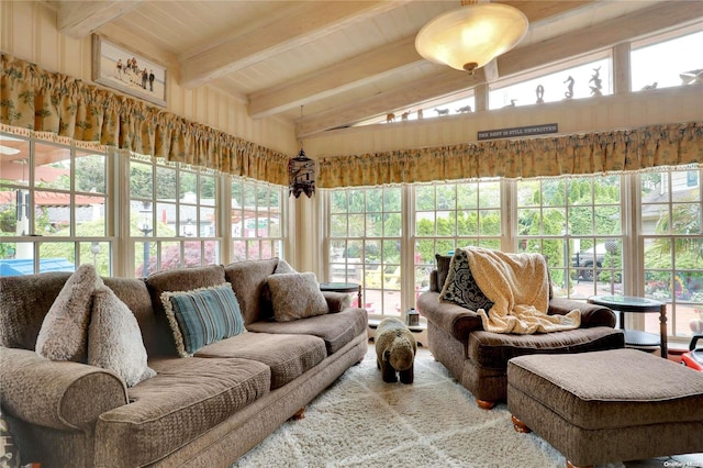 sunroom / solarium with vaulted ceiling with beams, plenty of natural light, and wood ceiling