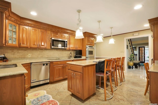 kitchen featuring sink, a center island, backsplash, decorative light fixtures, and appliances with stainless steel finishes