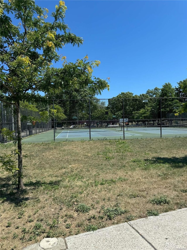 view of yard featuring basketball hoop and tennis court