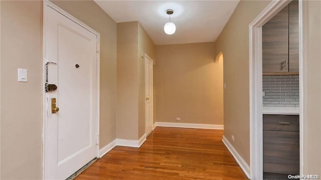 63-60 102nd St Unit D9, Rego Park, NY 11374 - hallway featuring wood finished floors and arched walkways