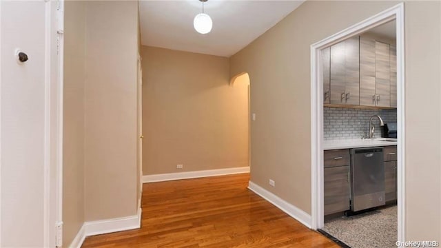 63-60 102nd St Unit D9, Rego Park, NY 11374 - corridor featuring arched walkways and light wood-style flooring