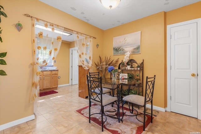 dining area featuring light tile patterned floors