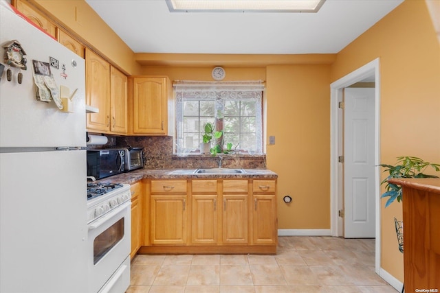 kitchen featuring white appliances, sink, light tile patterned floors, light brown cabinetry, and tasteful backsplash