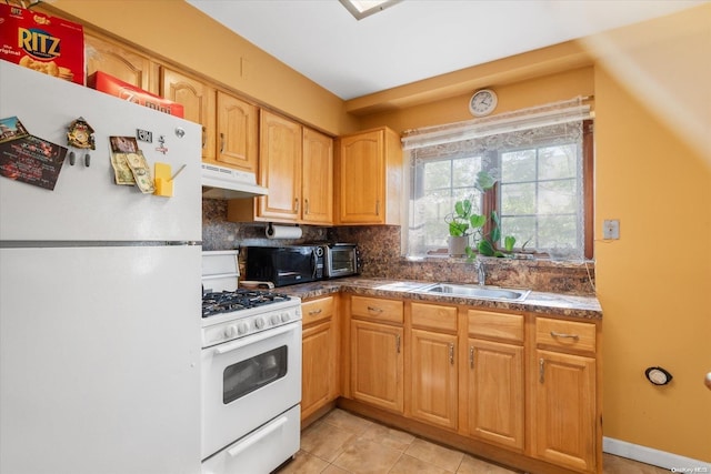 kitchen featuring decorative backsplash, white appliances, sink, and light tile patterned floors