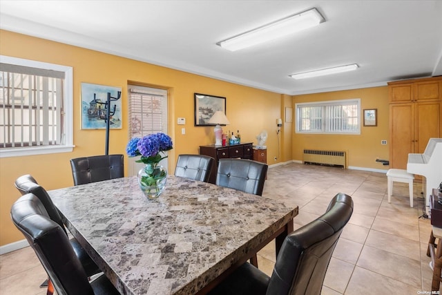 dining area with radiator heating unit and light tile patterned flooring