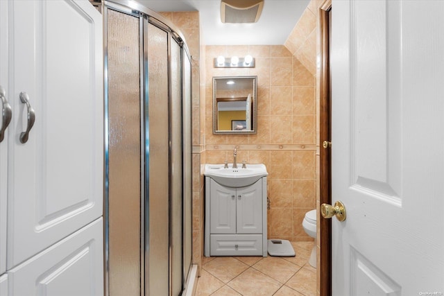 bathroom with tile patterned flooring, vanity, and tile walls