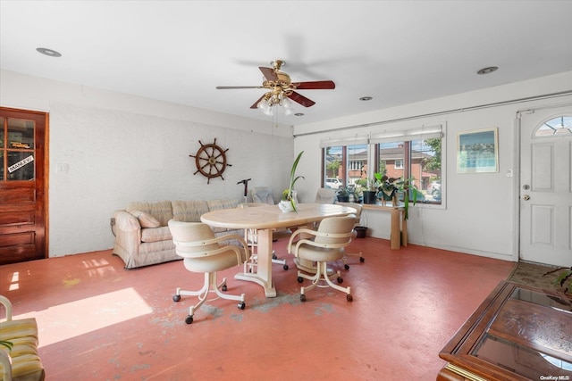 dining space with concrete flooring and ceiling fan