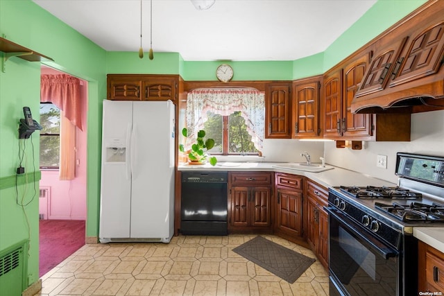 kitchen with light carpet, sink, radiator, and black appliances