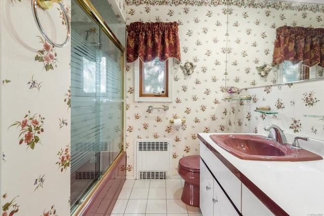 bathroom featuring toilet, radiator heating unit, vanity, and tile patterned floors