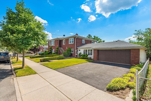 view of front of property featuring a garage and a front lawn