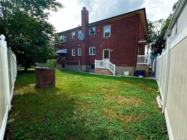 rear view of house featuring a lawn