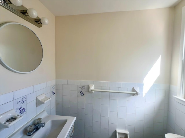 bathroom with sink and tile walls