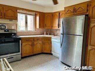 kitchen featuring tasteful backsplash, ceiling fan, extractor fan, and appliances with stainless steel finishes