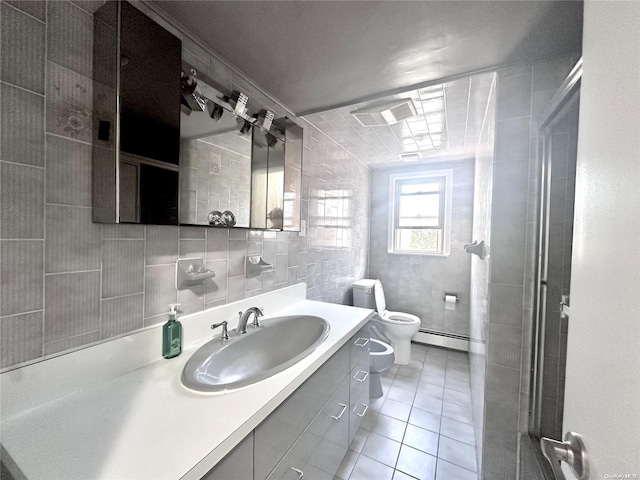 bathroom featuring vanity, a bidet, a baseboard heating unit, tile patterned floors, and toilet