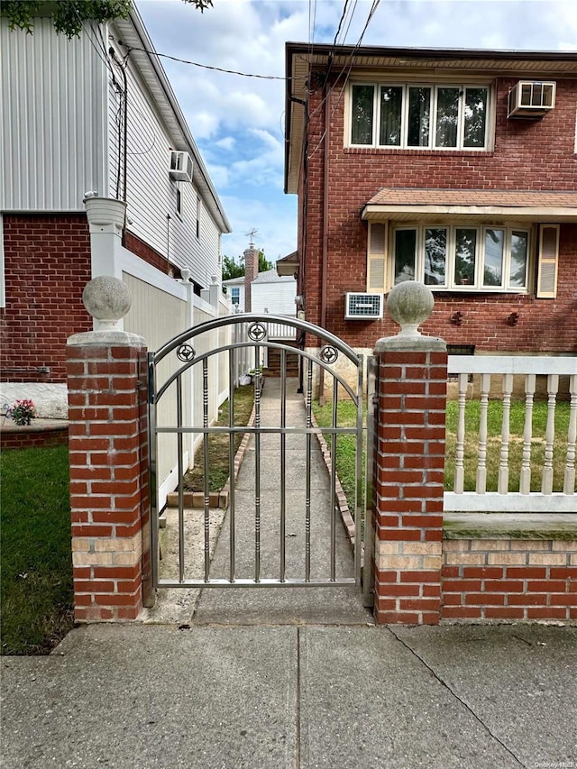 view of gate featuring an AC wall unit