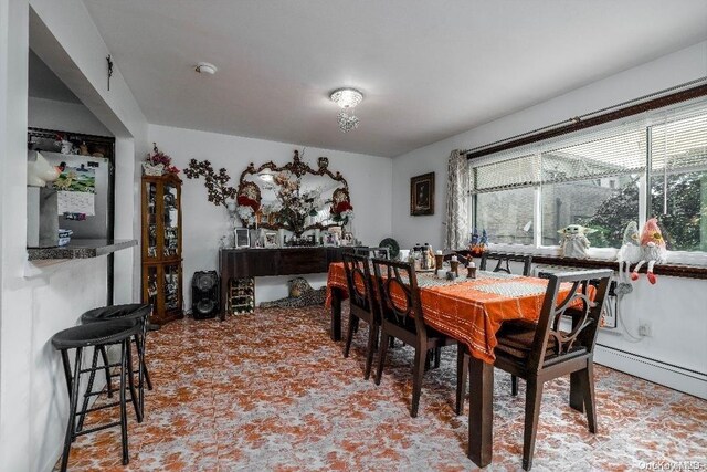 dining space featuring a baseboard heating unit