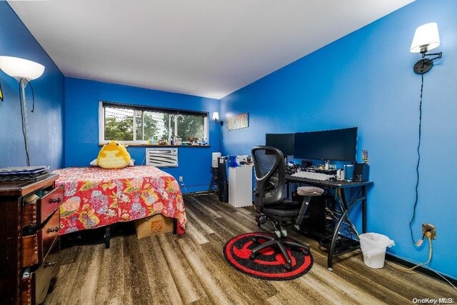 bedroom with hardwood / wood-style flooring