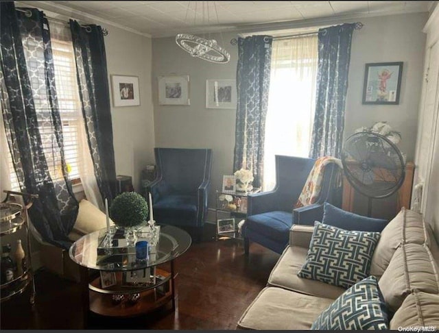 sitting room with hardwood / wood-style flooring and crown molding