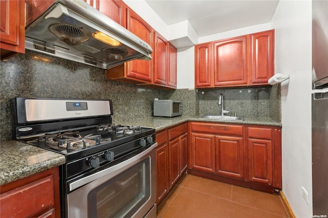 kitchen featuring decorative backsplash, sink, exhaust hood, and stainless steel range with gas stovetop