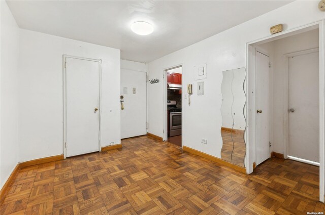 spare room with dark parquet flooring