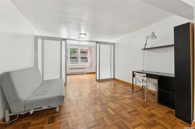 sitting room featuring radiator and dark parquet flooring