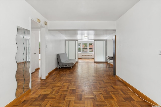 hallway featuring dark parquet floors and radiator