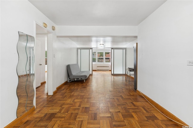 corridor with radiator and dark parquet floors