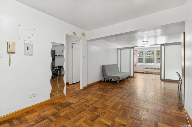 unfurnished room with dark parquet flooring and radiator