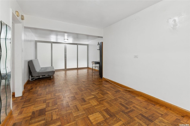 unfurnished room featuring dark parquet floors