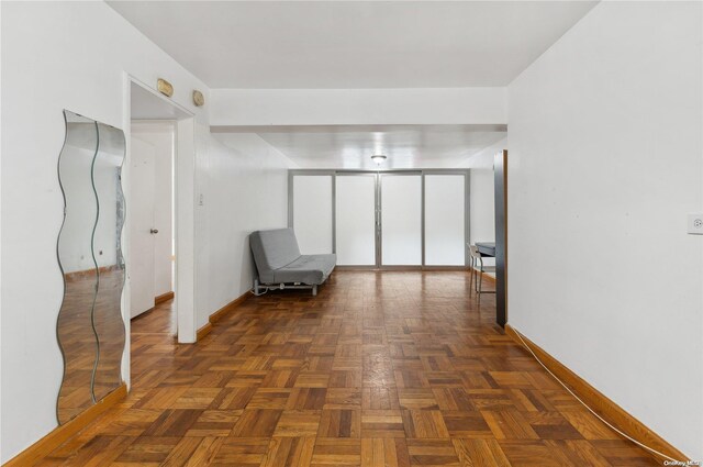 unfurnished room with dark parquet flooring