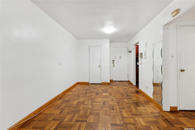 corridor featuring dark parquet flooring