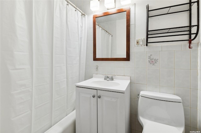 bathroom with vanity, toilet, tile walls, and radiator