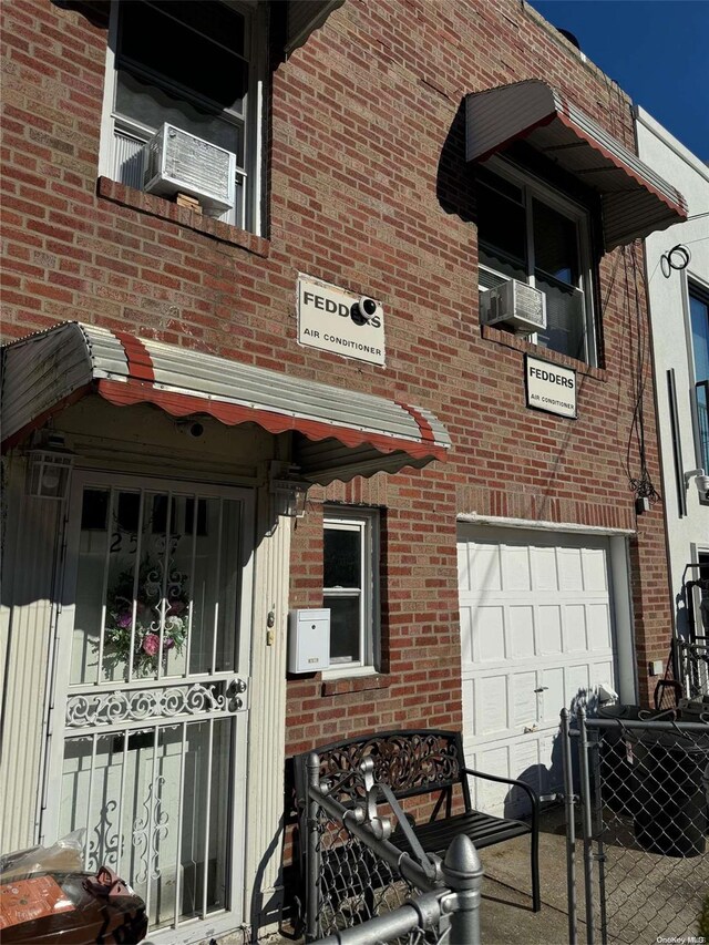 25-37 48th St, Astoria, NY 11103 - property entrance featuring a garage and brick siding