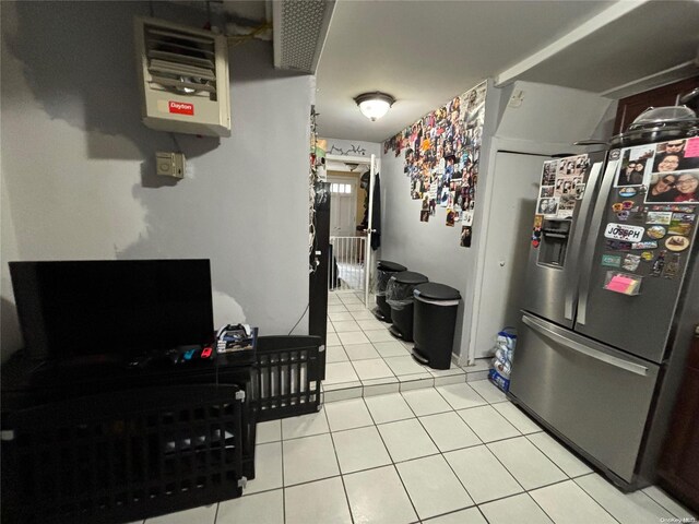 25-37 48th St, Astoria, NY 11103 - kitchen featuring stainless steel refrigerator with ice dispenser, light tile patterned floors, and a heating unit
