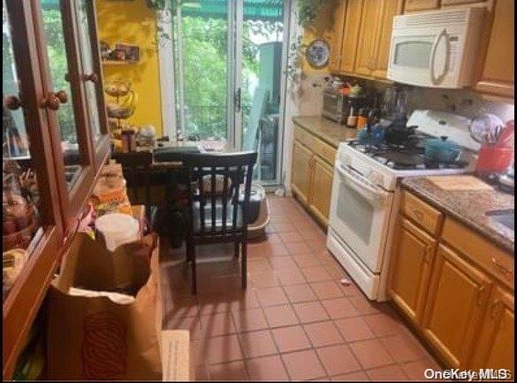 25-37 48th St, Astoria, NY 11103 - kitchen with white appliances and light tile patterned floors