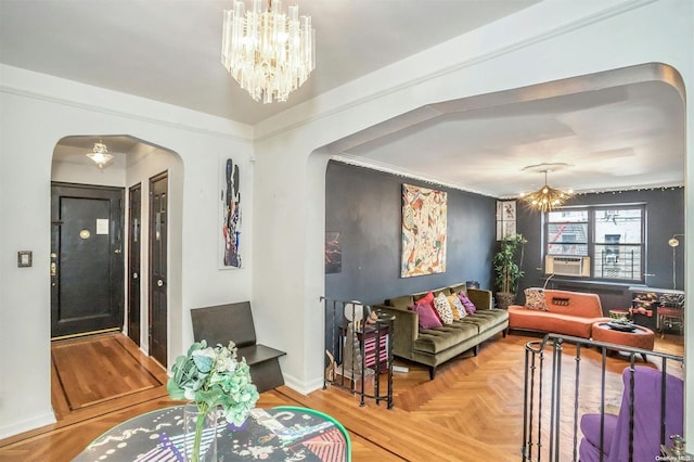 living room with cooling unit, an inviting chandelier, parquet floors, and crown molding