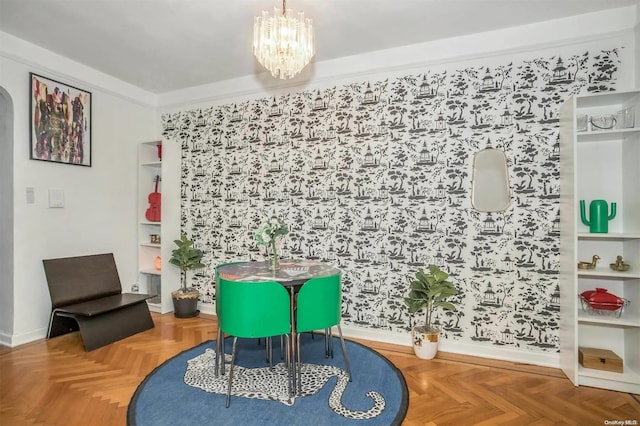 living area featuring parquet floors, crown molding, and an inviting chandelier