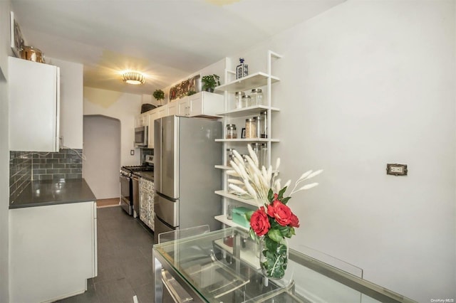 kitchen featuring appliances with stainless steel finishes, tasteful backsplash, and white cabinetry