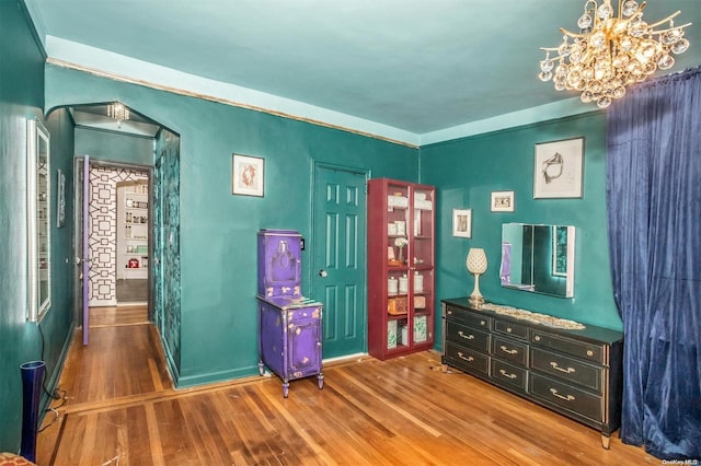 misc room with hardwood / wood-style floors and an inviting chandelier