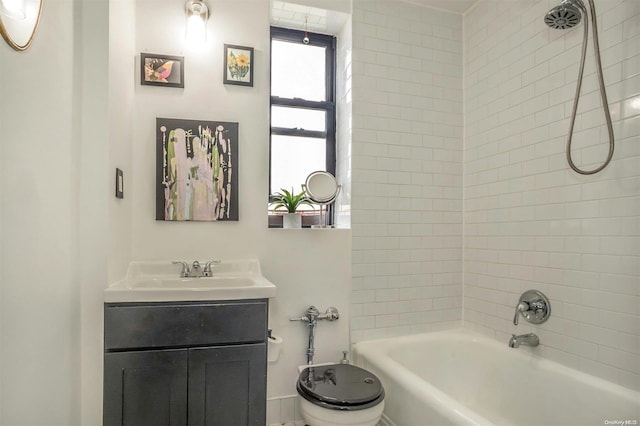 full bathroom featuring toilet, vanity, and tiled shower / bath