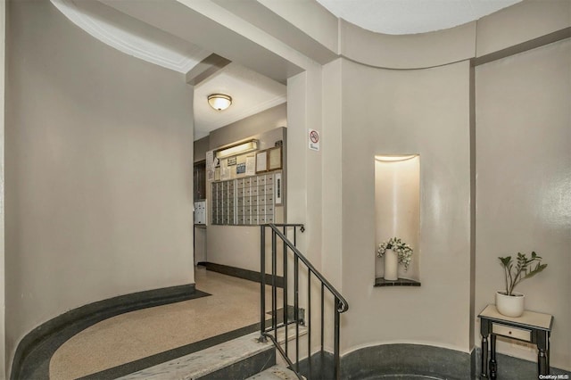 staircase with a mail area and ornamental molding